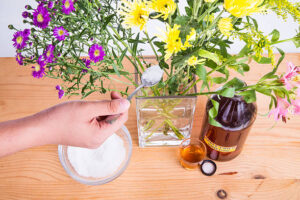 Hand Pouring Sugar Into Vase With Water 