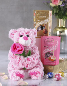 Pink teddy bear with two boxes of Lindt chocolates 
