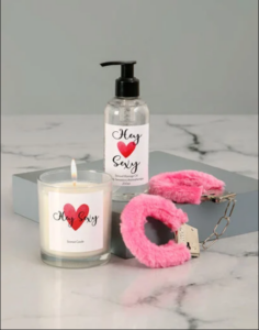 Massage oil, scented candle and fluffy playful handcuffs