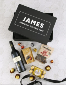 A personalised giftbox with a wine bottle, biltong and Lindt chocolates
